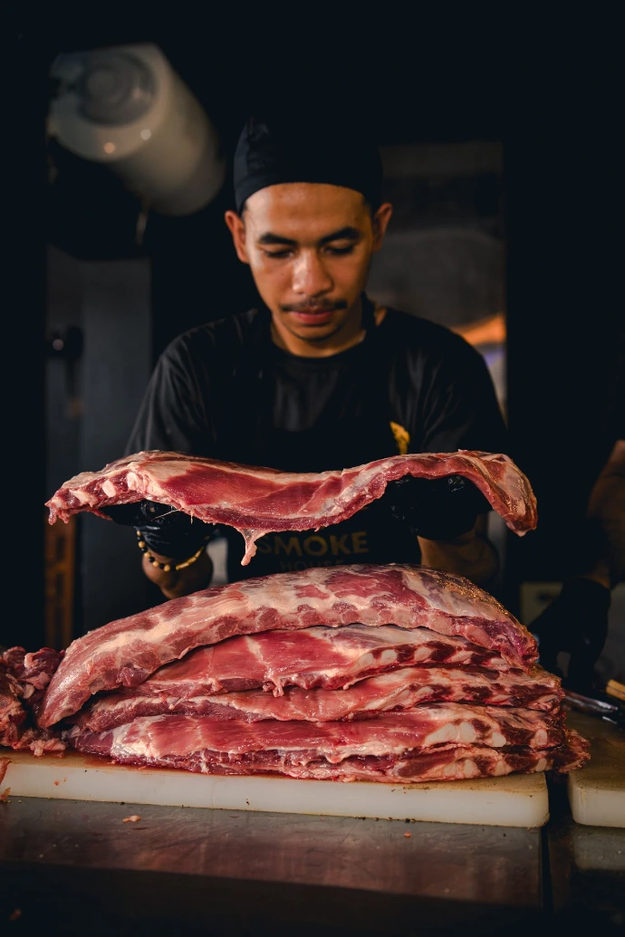Pitmaster preparing Pork spare ribs at Smoke House Komodo, Labuan Bajo